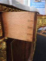 Lot 505 - A French Louis XVI style marble top plum pudding mahogany ebony and ormolu mounted commode