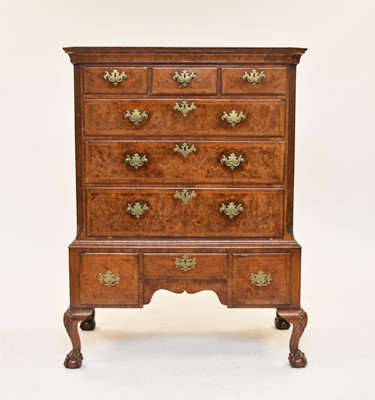Lot 400 - A George II feather-banded walnut chest on later stand
