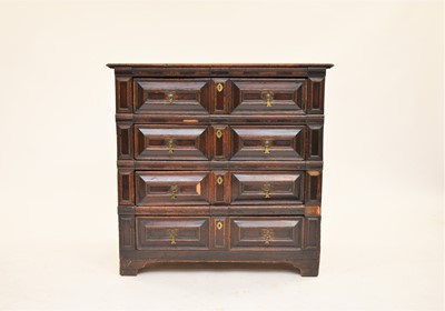 Lot 392 - An early 18th century oak geometric fronted chest of drawers