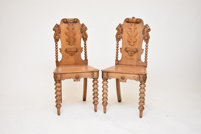 Lot 418 - A pair of Victorian carved oak hall chairs