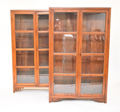 Lot 438 - A pair of South East Asian hardwood glazed bookcases