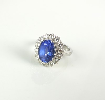 Lot 238 - An 18ct white gold tanzanite and diamond cluster ring