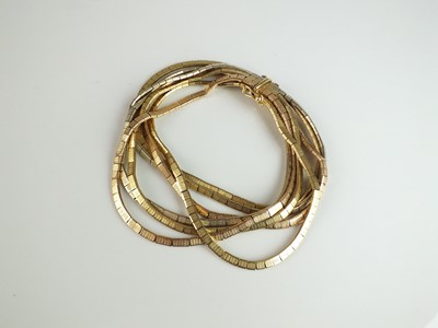 Lot 270 - A yellow, white and rose metal multi-strand bracelet