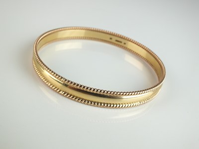 Lot 257 - A 9ct gold bangle