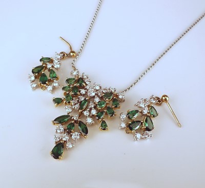 Lot 265 - An 18ct gold diamond and emerald pendant with matching earrings
