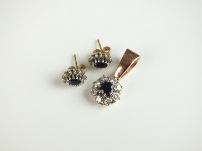 Lot 301 - A diamond and sapphire floral cluster pendant and earrings
