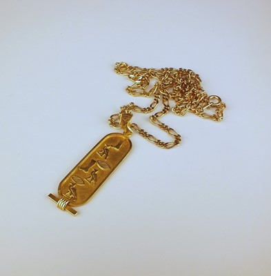 Lot 253 - A yellow metal Egyptian hieroglyph ingot pendant