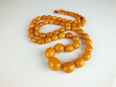 Lot 297 - A graduated oval amber bead necklace