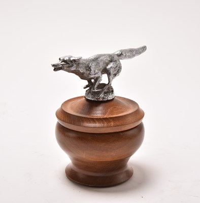 Lot 144 - A turned wooden bowl with removable cover set with a white metal finial of a running fox