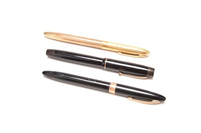 Lot 110 - Shaeffer: An 18ct gold and gold plated fountain pen, with two further pens
