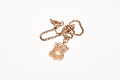 Lot 294 - A yellow metal curb link chain with 9ct gold shield fob