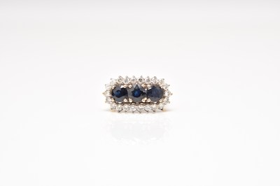 Lot 248 - An 18ct gold sapphire and diamond ring