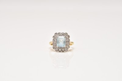 Lot 124 - An 18ct gold aquamarine and diamond cluster ring