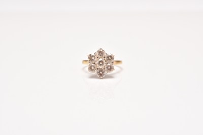Lot 143 - An 18ct gold seven stone diamond floral cluster ring
