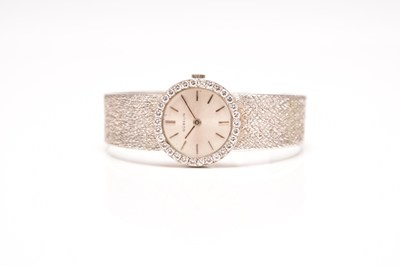 Lot 326 - Gubelin: A lady's 18ct white gold diamond set bracelet watch