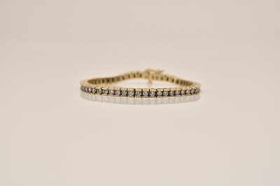 Lot 142 - A diamond set line bracelet