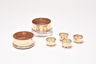 Lot 50 - A pair of silver mounted wine coasters and four silver tea light holders
