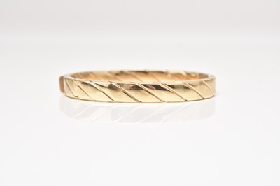 Lot 164 - A 9ct gold hinged bangle