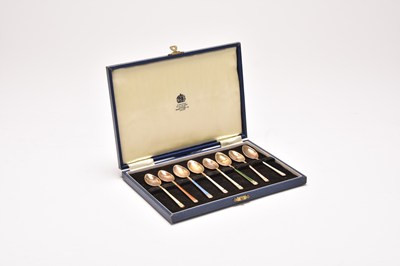 Lot 33 - A cased set of eight silver and enamel coffee spoons