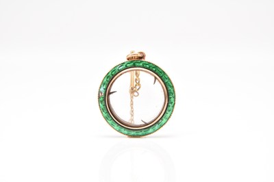 Lot 153 - A green enamel and yellow metal pendant locket pendant