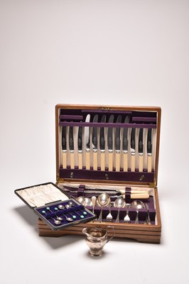 Lot 54 - A cased canteen of silver plated cutlery, a silver cream jug and silver coffee spoons