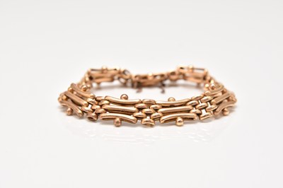 Lot 319 - A yellow metal three bar gate link bracelet
