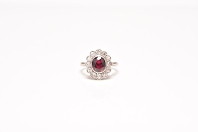 Lot 221 - A garnet and diamond cluster ring