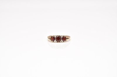 Lot 245 - A 9ct gold garnet and diamond ring