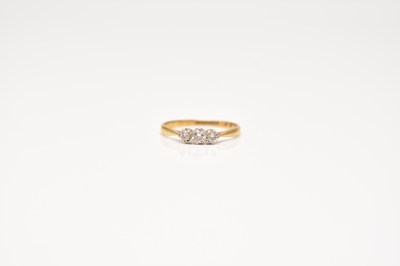 Lot 234 - A graduated three stone diamond ring