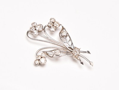 Lot 134 - A diamond set floral spray brooch